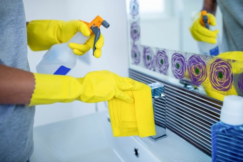 Professional cleaner working in a Bromley business corridor